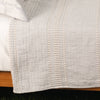 Cream TerraCotton Blanket on bed